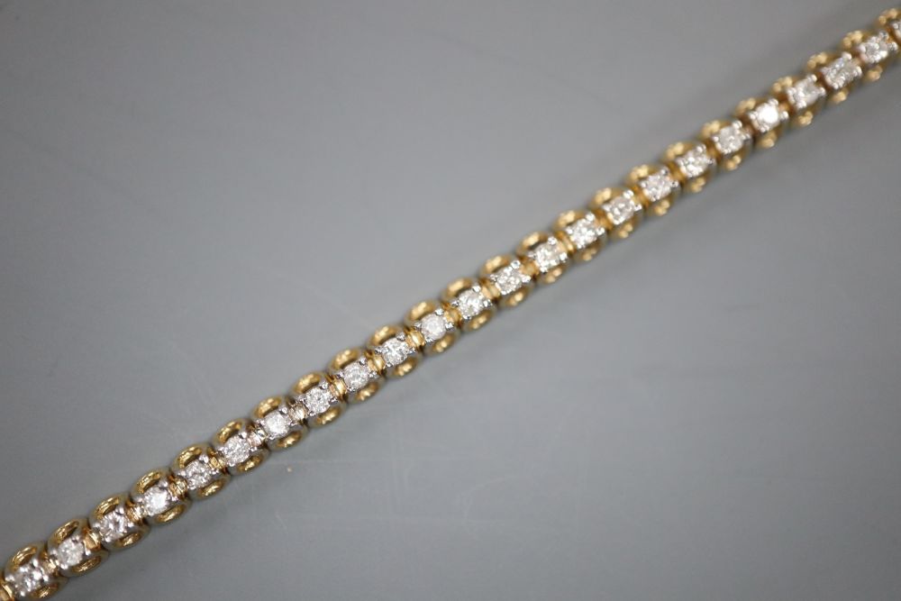 A modern 9ct gold and diamond set line bracelet, 17.7cm, gross 7 grams,